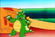 King Koopa standing in front of his Crud Cannon.