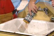 Mario, sprinking a canister of Mario Brothers Clog Cleaner down a drain.