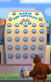 Donkey Kong overlooking the building of the Mario Toy Company.