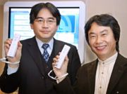 Satoru Iwata and Shigeru Miyamoto together, holding their Wiimotes.