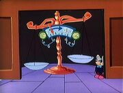 Bailiff Mouser, standing next to the Scales of Justice.